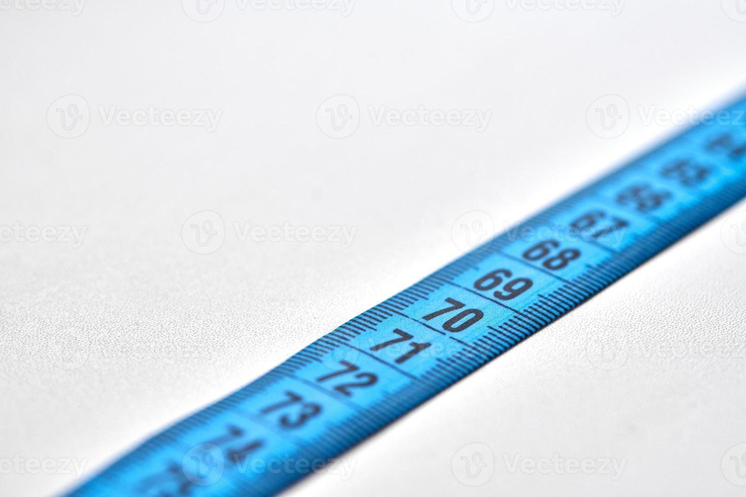 Blue measuring tape isolated on white background photo