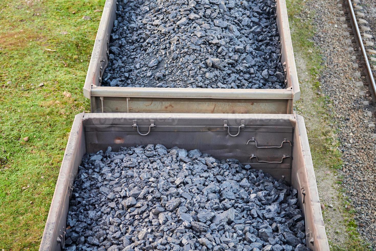 Freight train with cargo cars transporting coal, wood, fuel photo