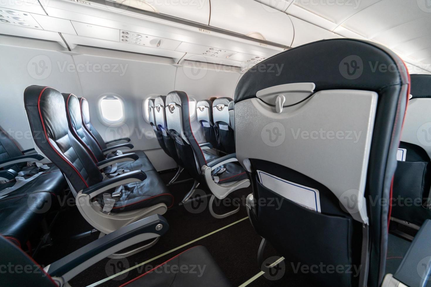 Airplane seats and windows. Economy class comfortable seats without passengers. New low-cost carrier airline photo