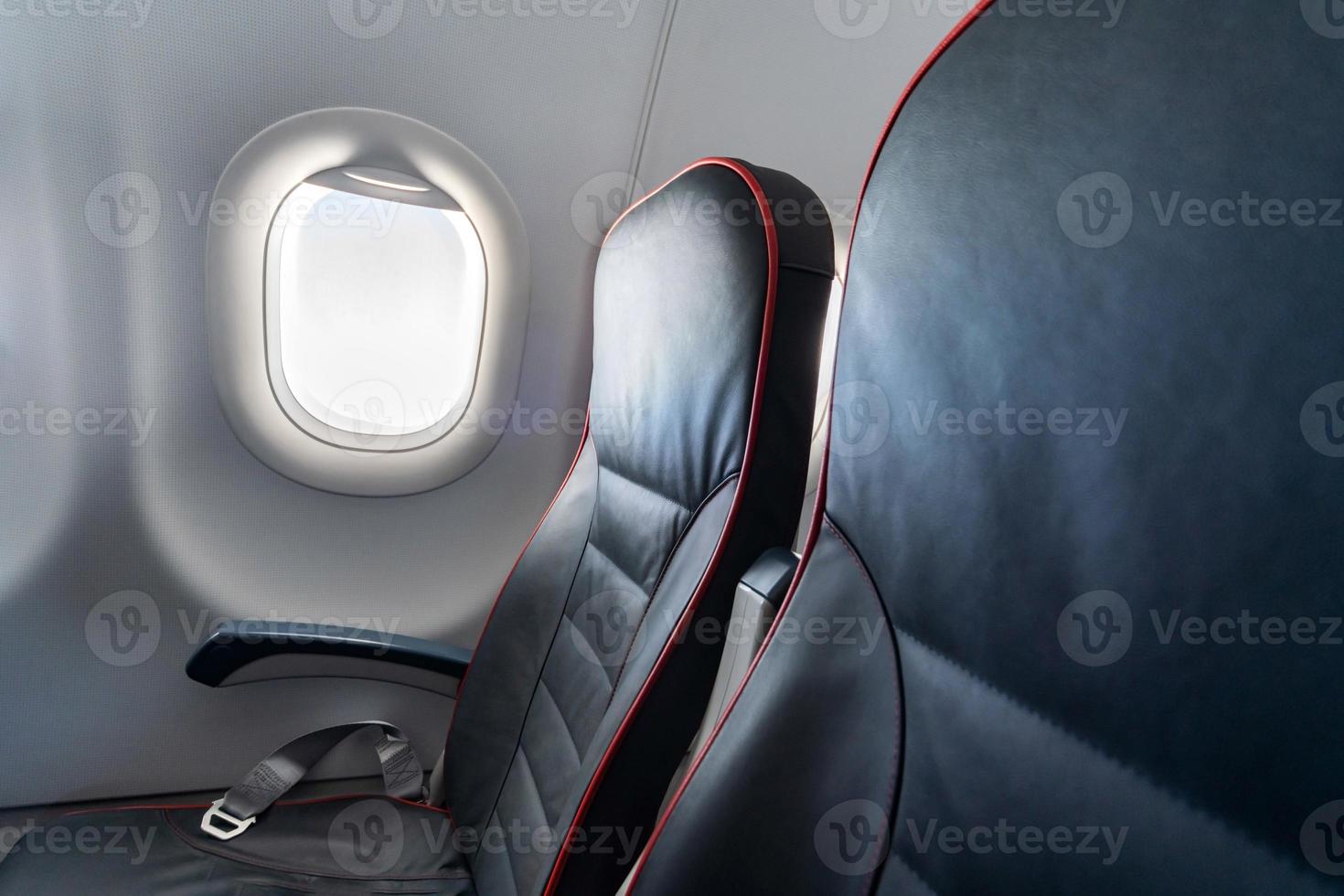 Airplane seats and windows. Economy class comfortable seats without passengers. New low-cost carrier airline photo