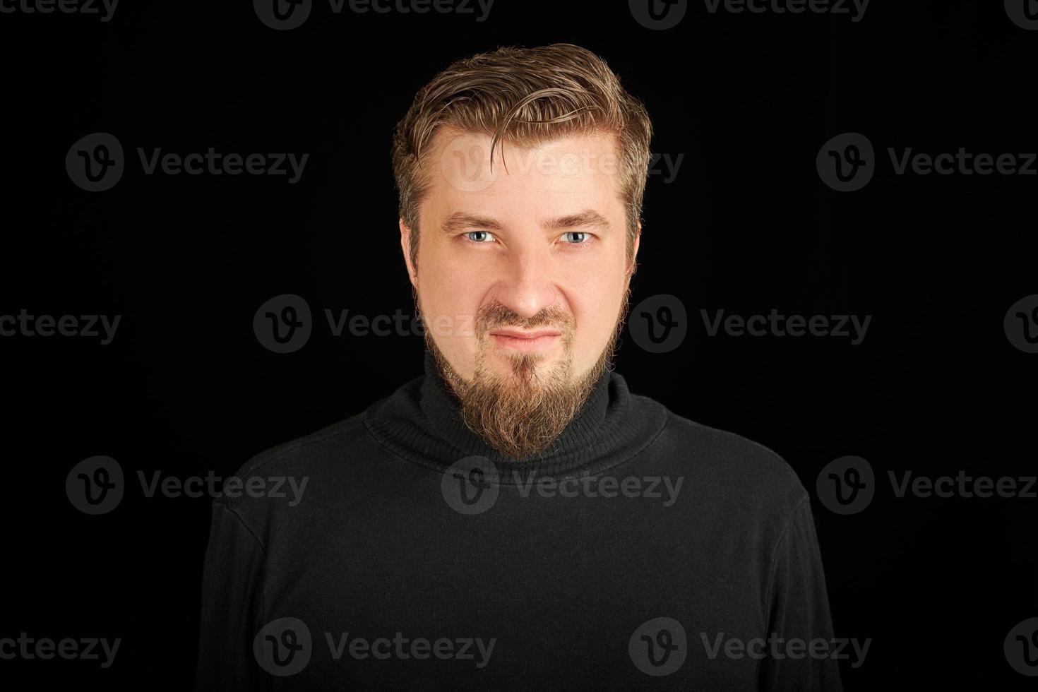 Cute bearded young guy in black polo neck sweater. photo
