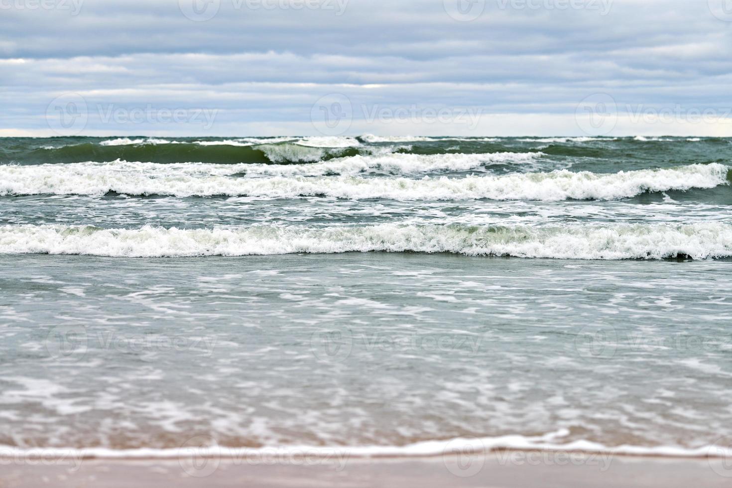 Blue sea, waves, beach and cloudy sky. Baltic Sea landscape photo