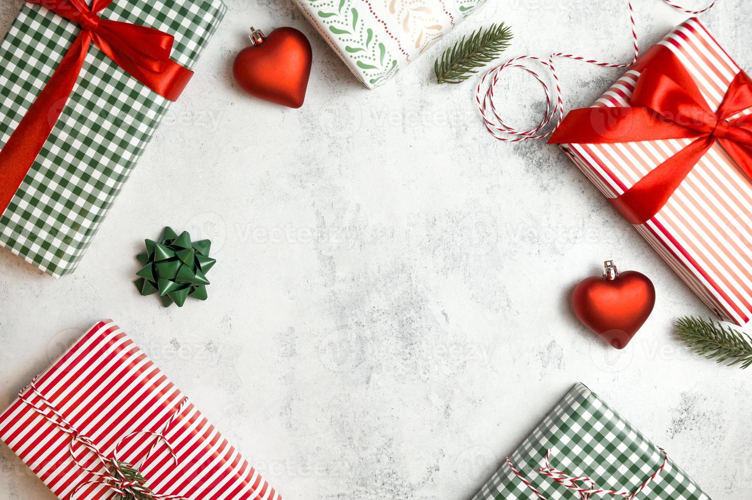 Winter holidays flat banner with place for text. Colorful presents in red,white and green with ornaments on concrete background photo