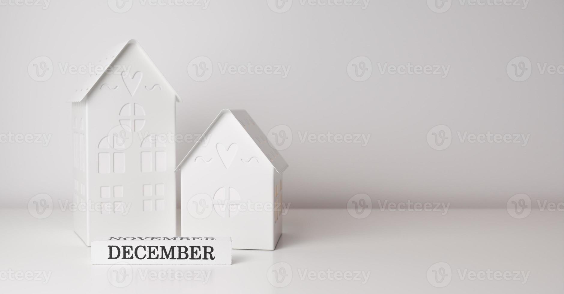 White winter banner with toy houses and december sign. Beginning of winter. Season holidays.Place for text photo