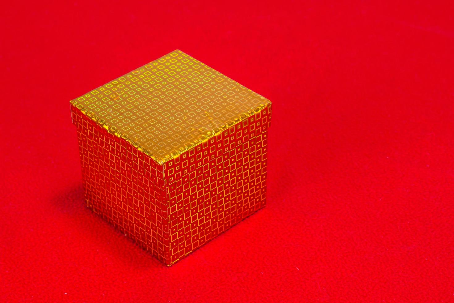 Shiny Christmas Gift Box On Red Background photo