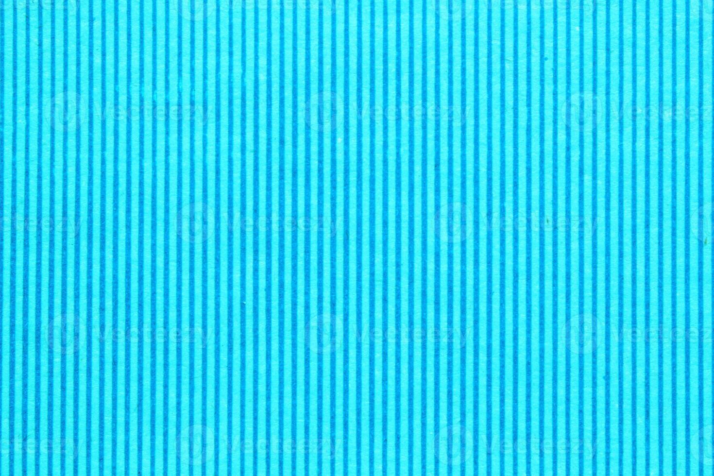 Abstract paper blue and aquamarine geometric symmetrical texture striped surface vertical lines background. Structure design cardboard shape backdrop. Decoration interior concept. Flatlay, close-up photo