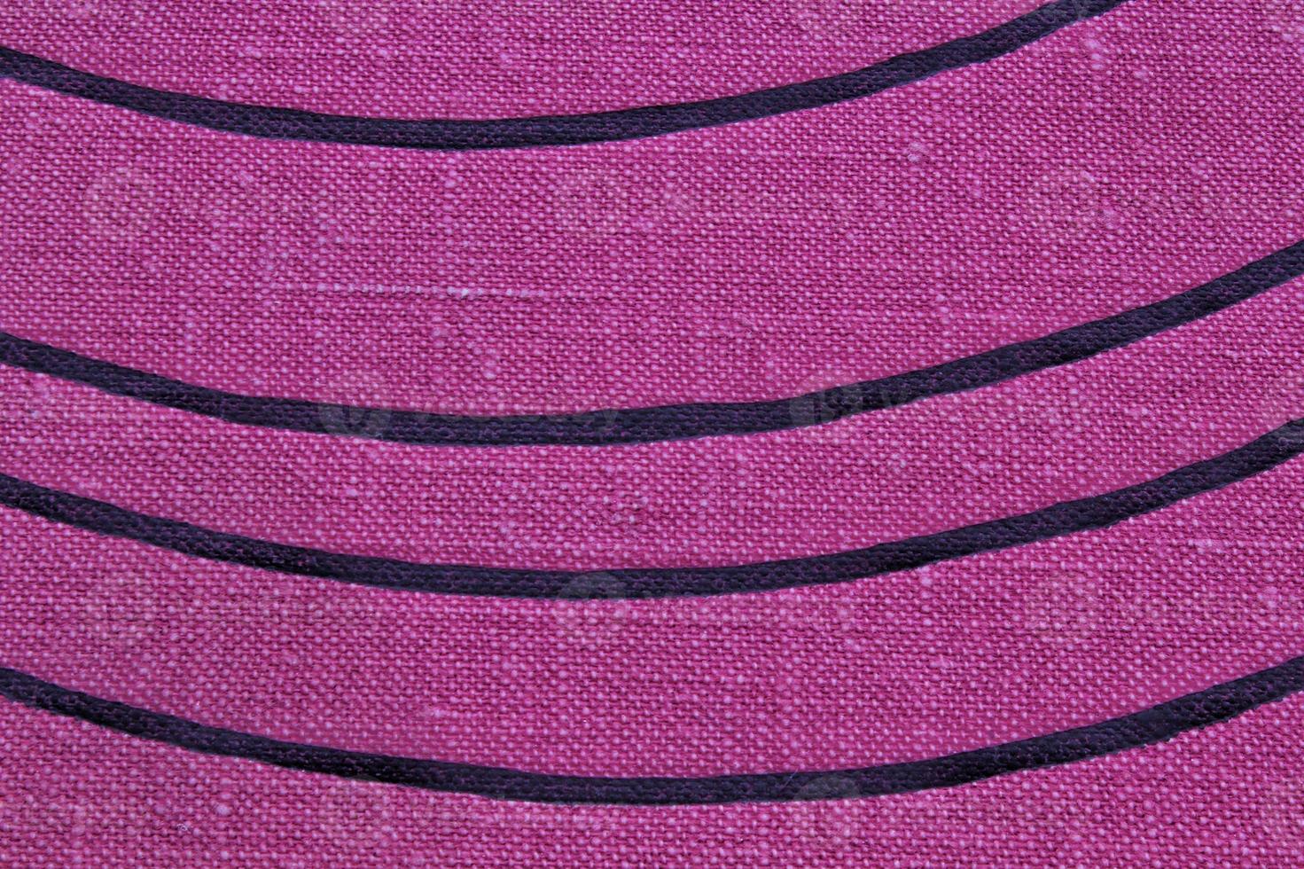 Abstract design background of violet coarse-grained intersection texture of rough fabric with an interlacing black painted lines. Linen sack textile canvas burlap cloth. Close-up, mock up, top view photo