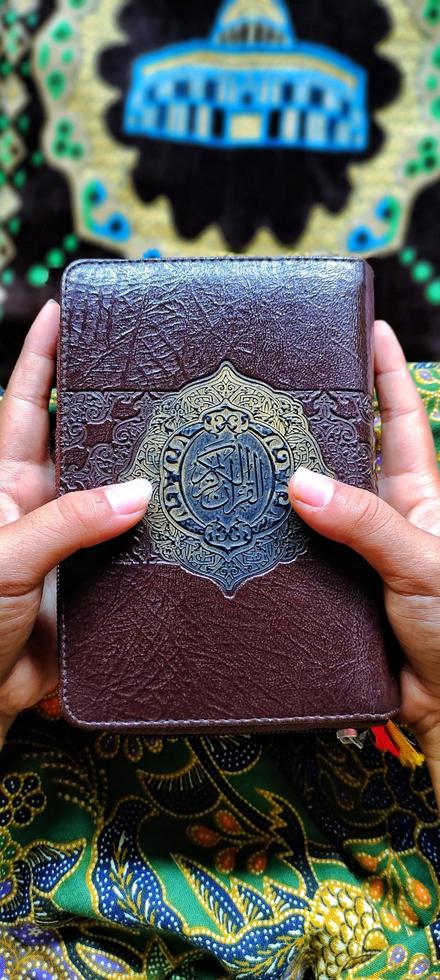 Portrait of the Holy Quran in hand photo