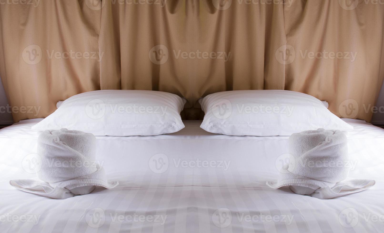 Two pillows on white bed photo