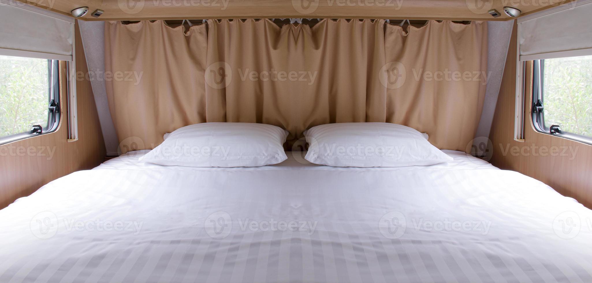 Inside of empty bed in camper van photo