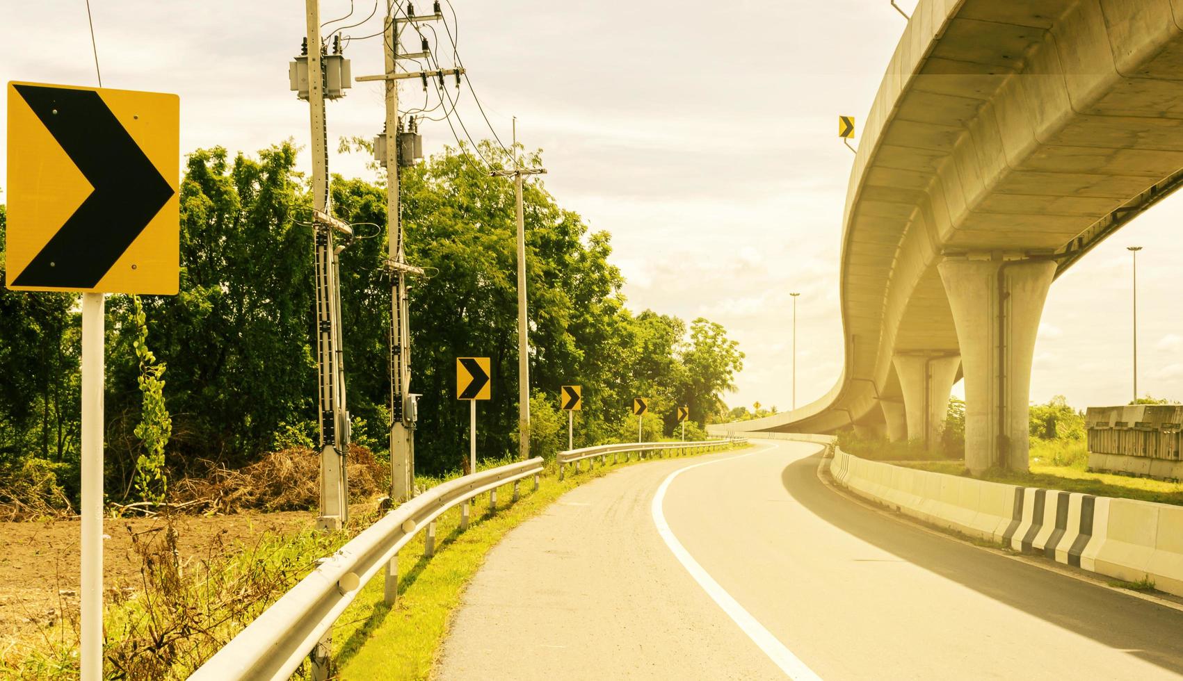 Yellow road sign on highway road photo