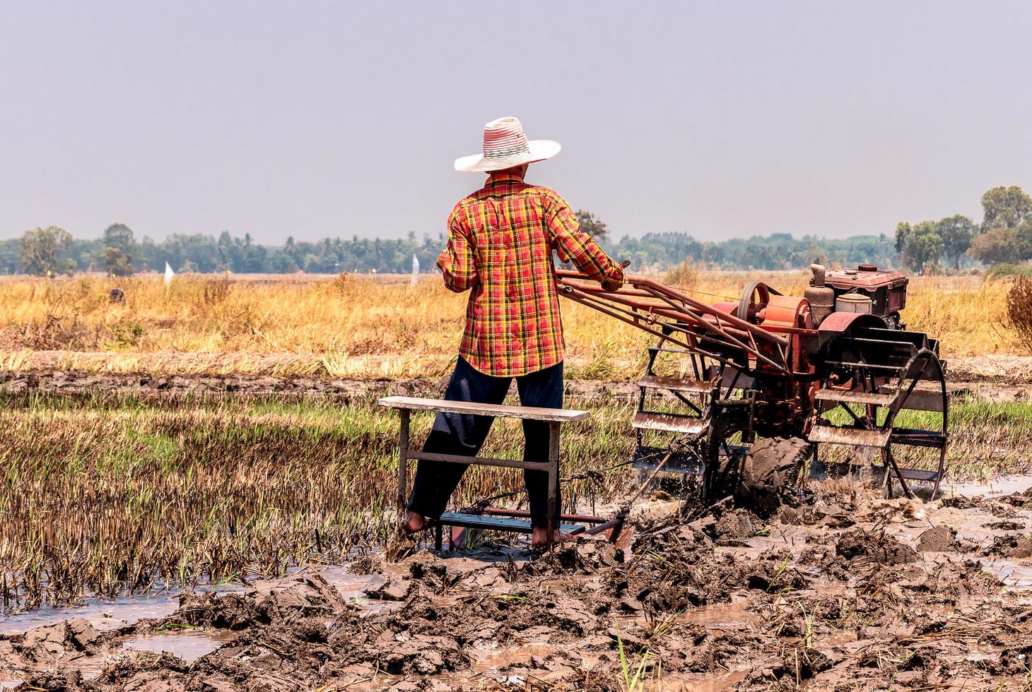 Farmer drives a plow on a field. photo