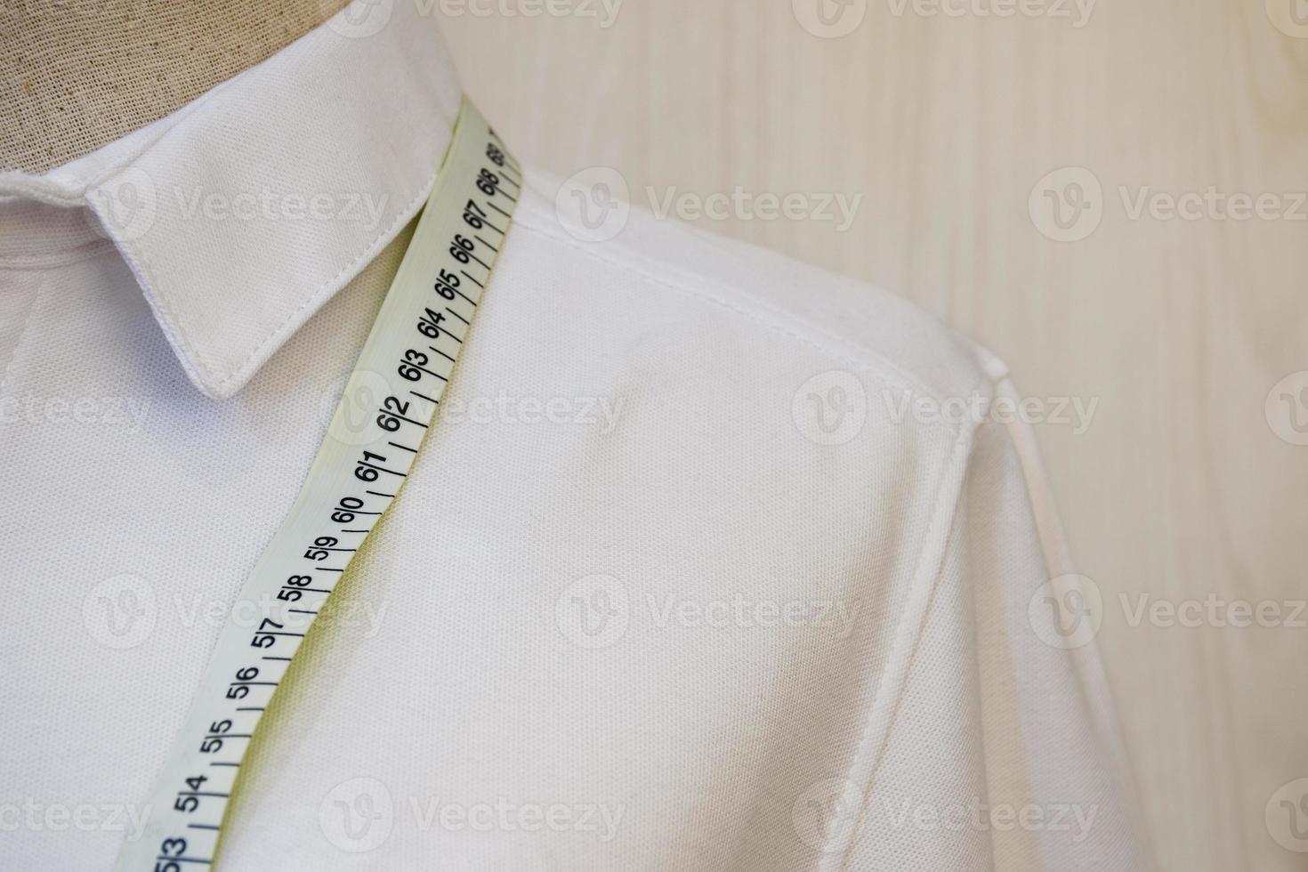 Close up mannequin with white shirt and waist measuring tape photo