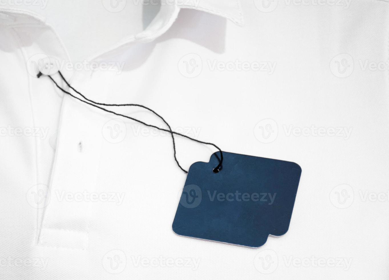 Blank blue price tag on white shirt photo