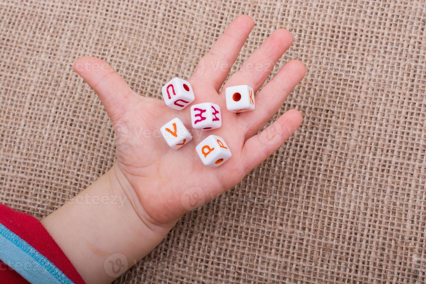 Colorful alphabet letter cubes in hand photo