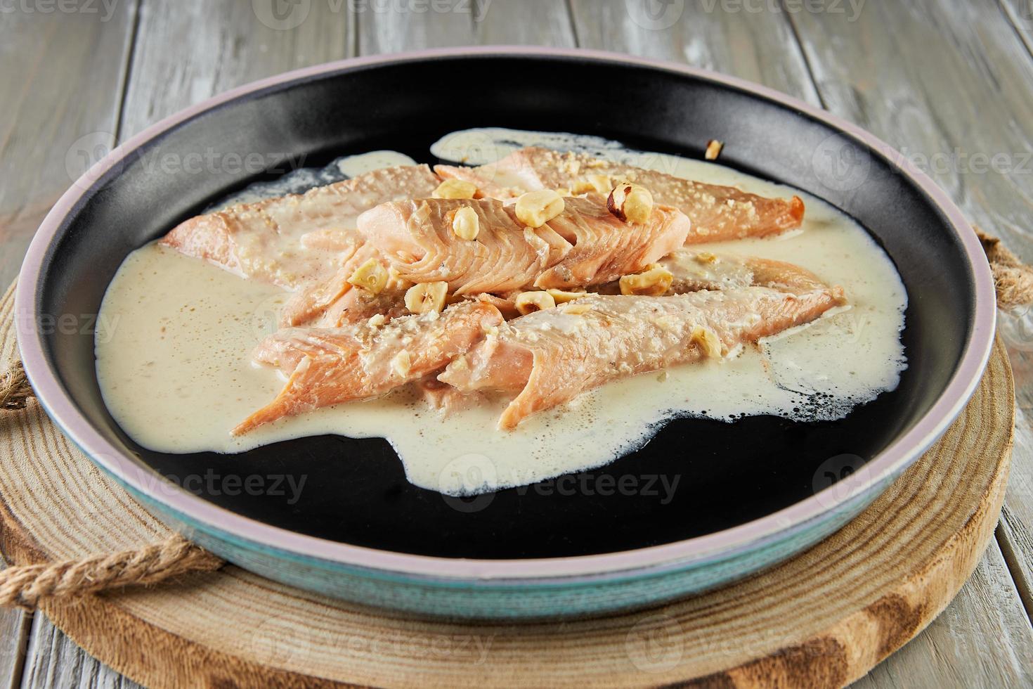 Salmon with cream sauce and nuts baked in the oven. French gourmet food photo