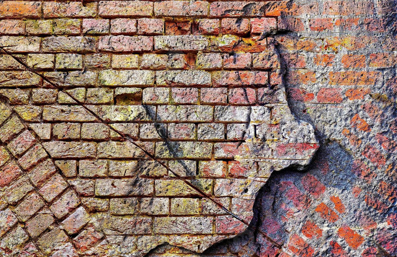 Detailed close up view on very old and weathered brick walls with cracks photo