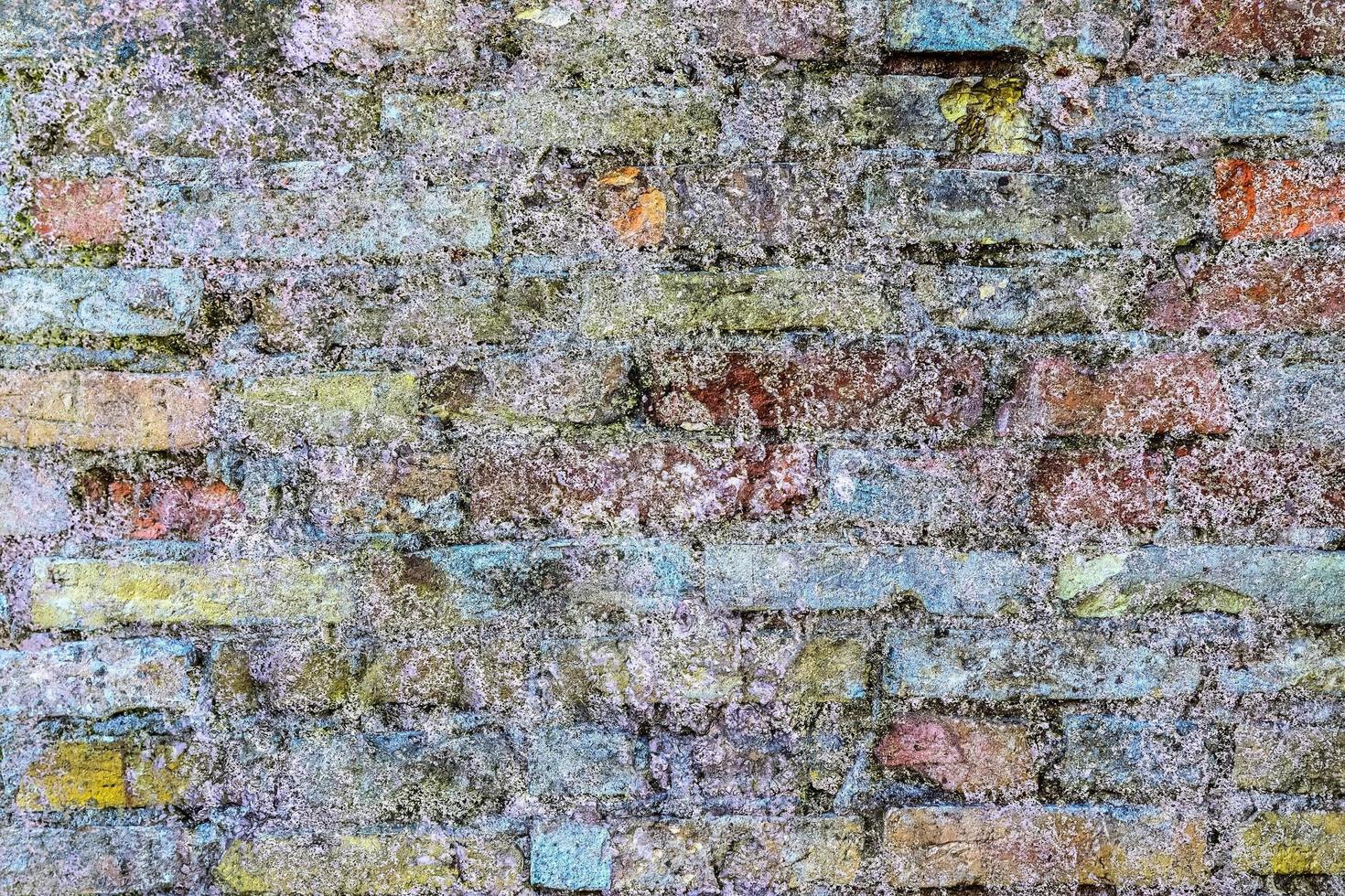 Detailed close up view on very old and weathered brick walls with cracks photo