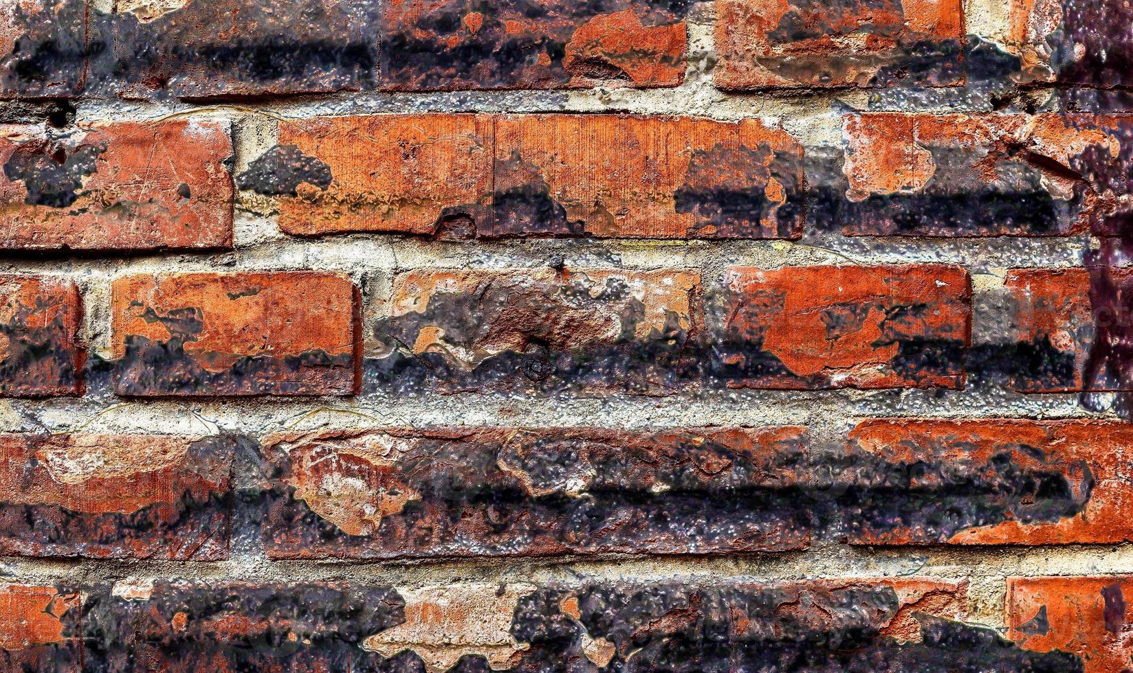 Detailed close up view on very old and weathered brick walls with cracks photo