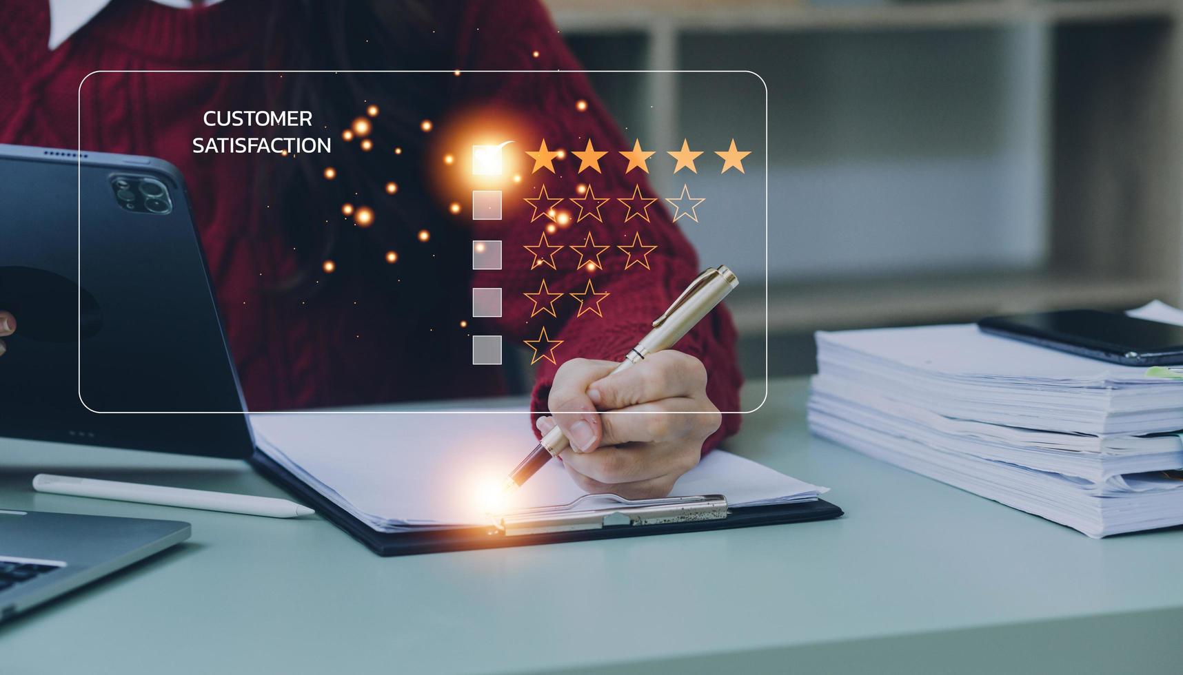 close up Man hand using computer Notebook with popup five star icon for feedback review satisfaction service, Customer service experience and business satisfaction survey. photo