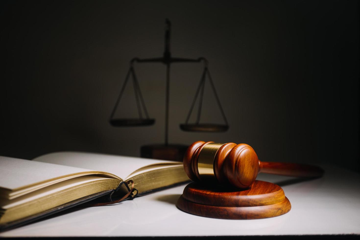 Business and lawyers discussing contract papers with brass scale on desk in office. Law, legal services, advice, justice and law concept photo
