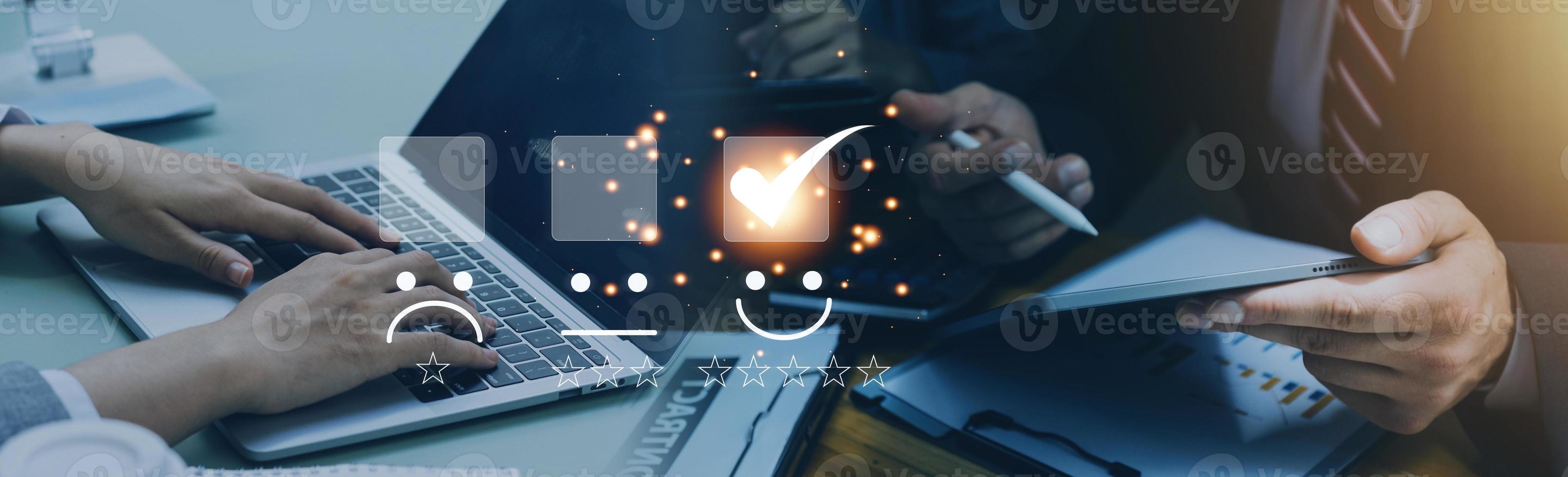Customer service and Satisfaction concept ,Business people are touching the virtual screen on the happy Smiley face icon to give satisfaction in service. rating very impressed. photo