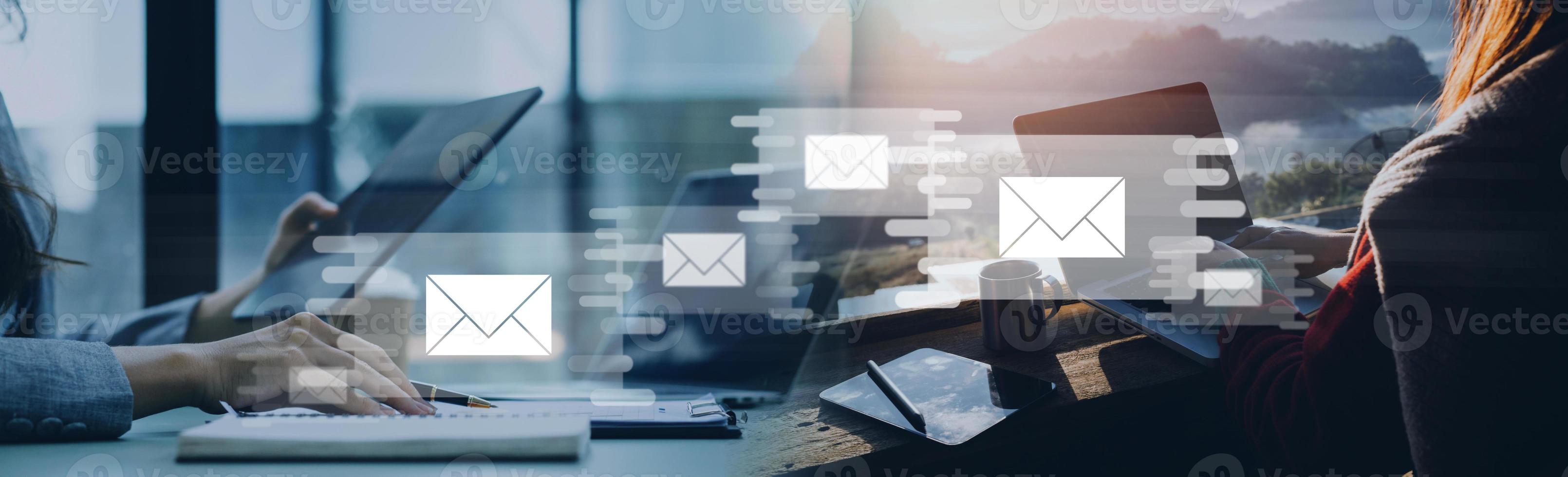 Businessman hands using Laptop typing on keyboard and surfing the internet on office table with email icon, email marketing concept, send e-mail or newsletter, online working internet network. photo
