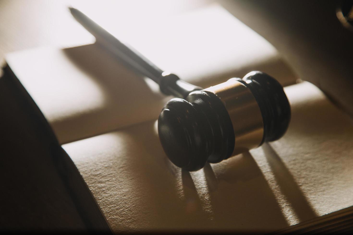 Business and lawyers discussing contract papers with brass scale on desk in office. Law, legal services, advice, justice and law concept photo