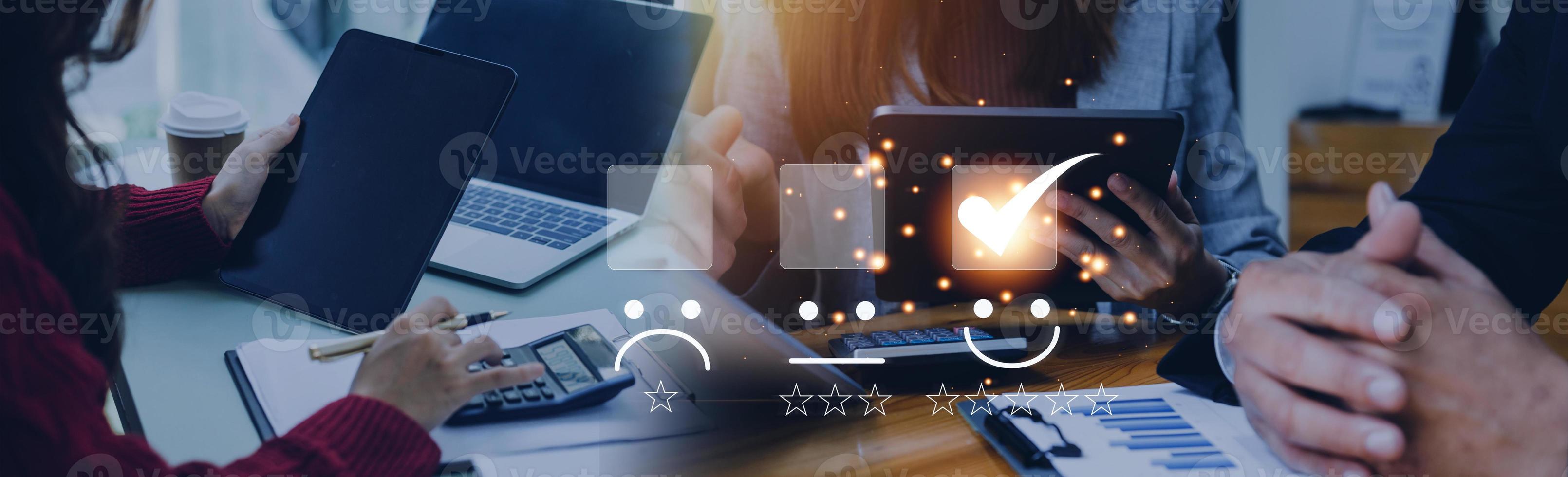 Customer service and Satisfaction concept ,Business people are touching the virtual screen on the happy Smiley face icon to give satisfaction in service. rating very impressed. photo