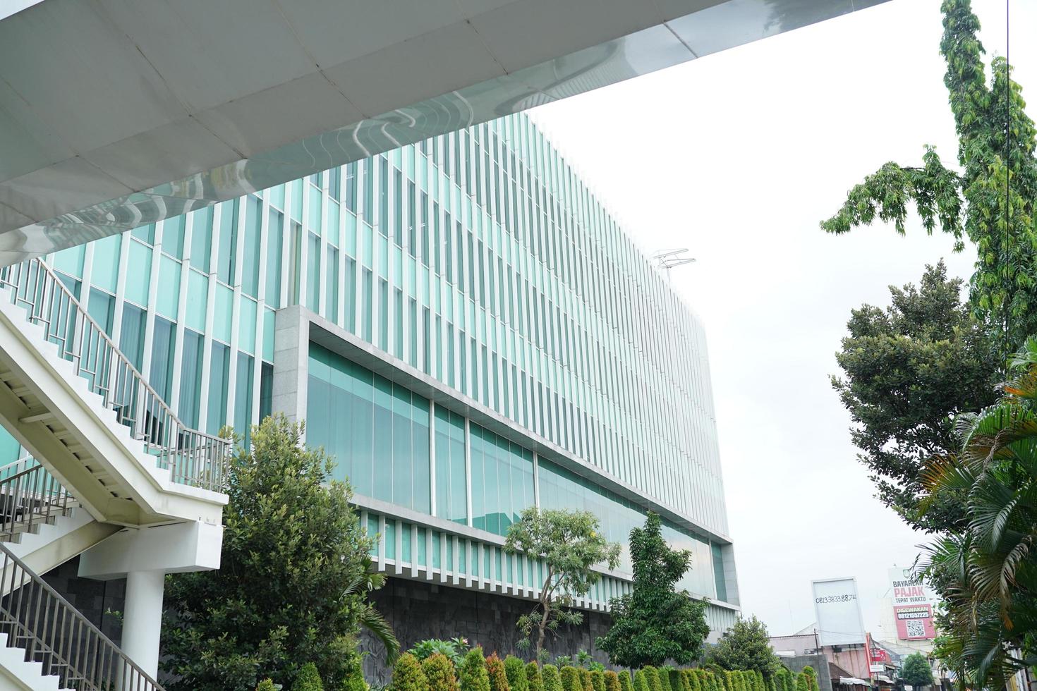 SOLO, INDONESIA - JUNE 9, 2022 Modern building frame, bridge with minimalist style glass building with white carved ornaments photo