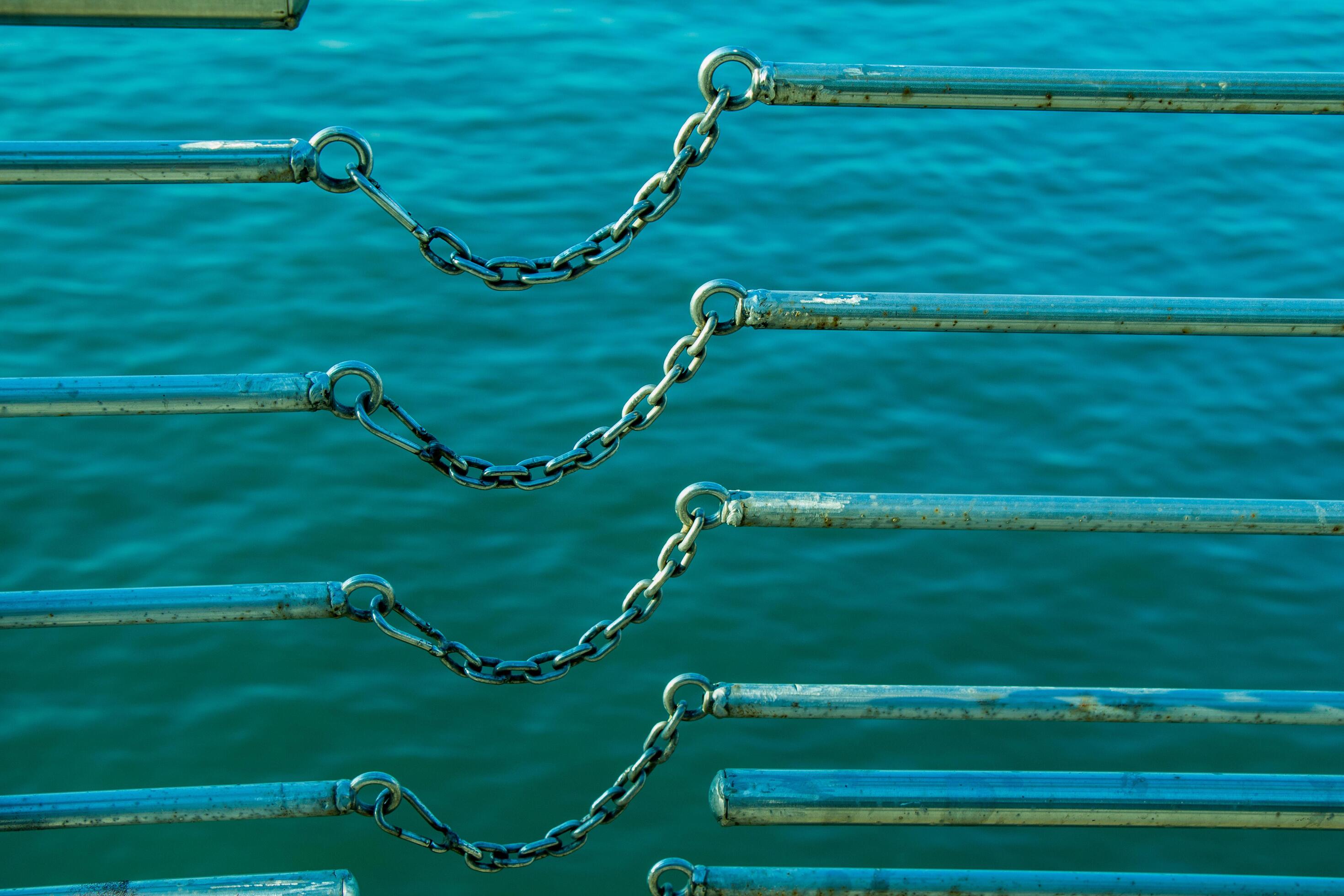 chain connects two metal bars over body of water 14877454 Stock Photo