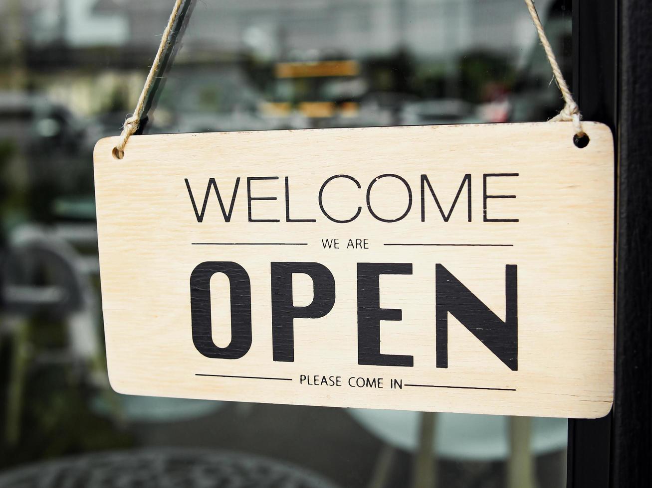 sign informing customers of cafes on holidays. Open sign on the glass door of the restaurant. service business idea open everyday photo