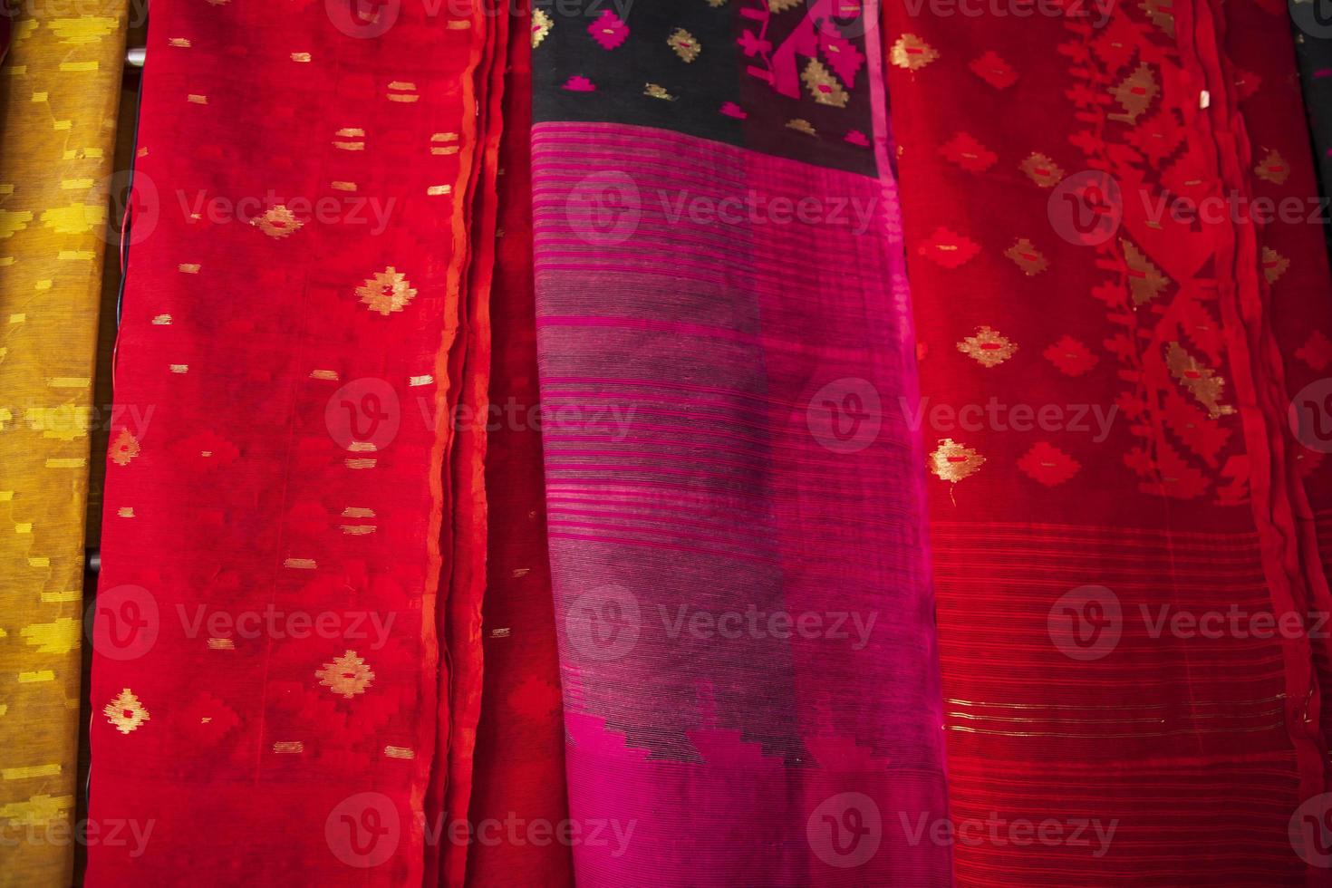 Bangladeshi Women,s Traditional Colorful Jamdani saree hanging in the retail Showrooms. Colorful Jamdani Saree Texture Background photo