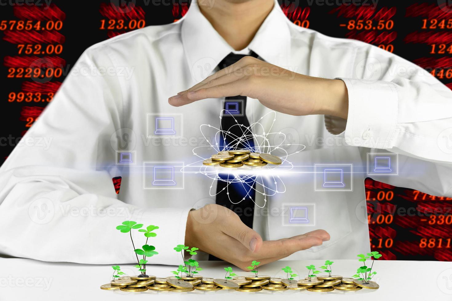 businessman hands protecting piles of golden coins with laptop icons,Lucky economic growth concept photo