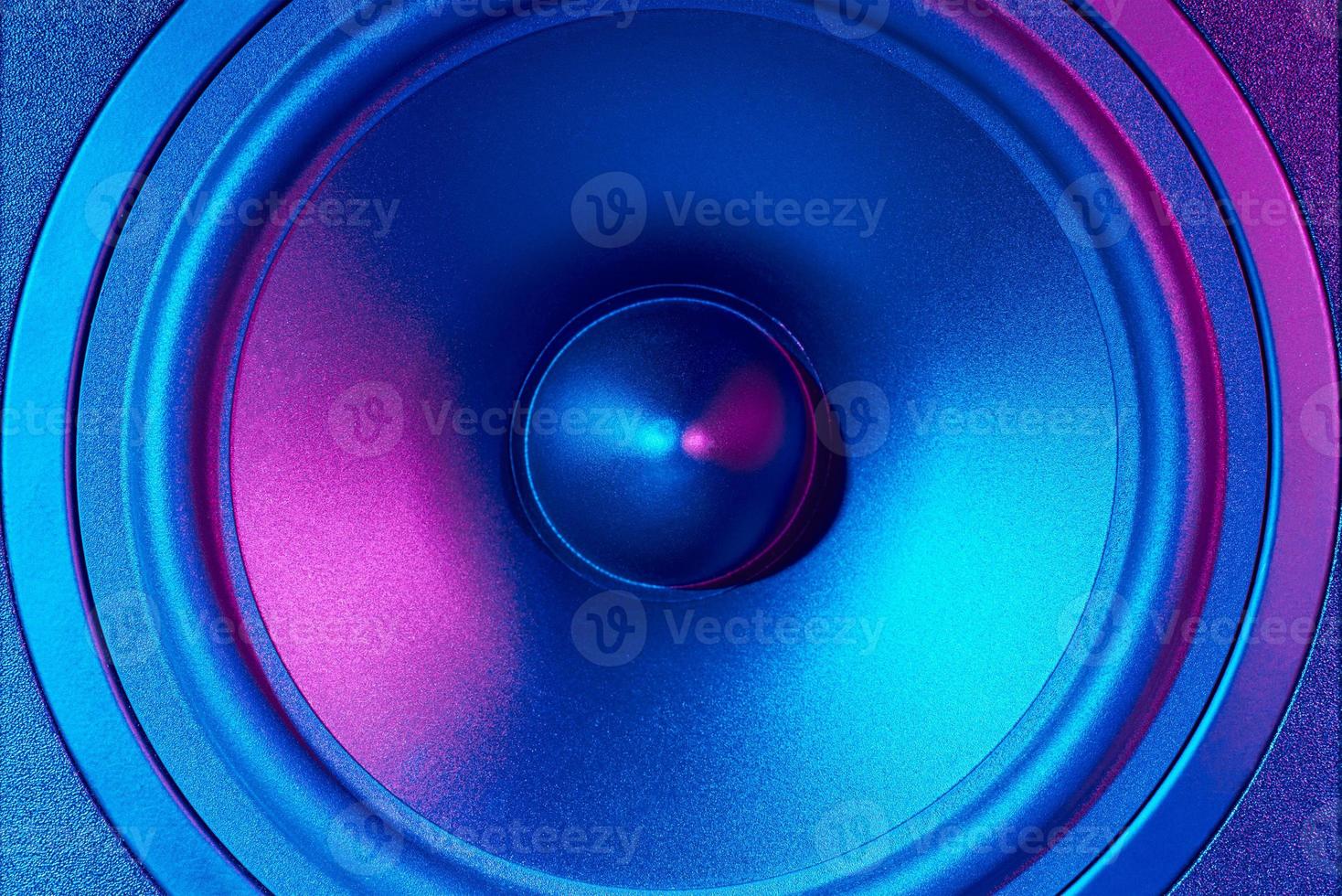 Sound audio speaker with neon lights on dark background photo