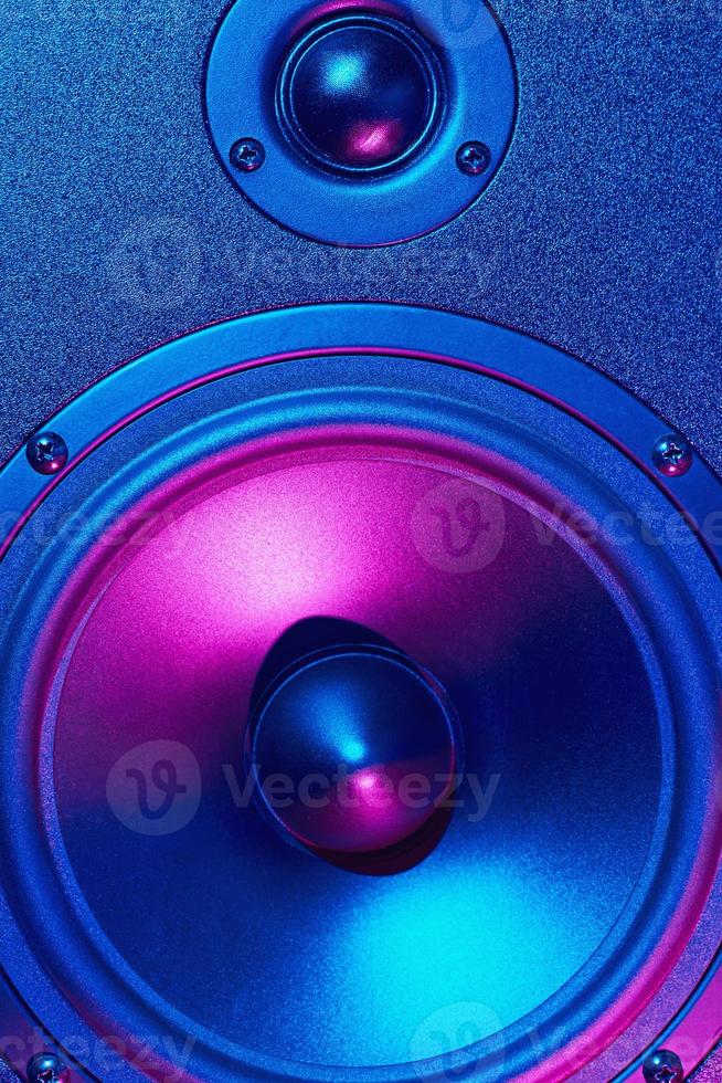 Sound audio speaker with neon lights on dark background photo