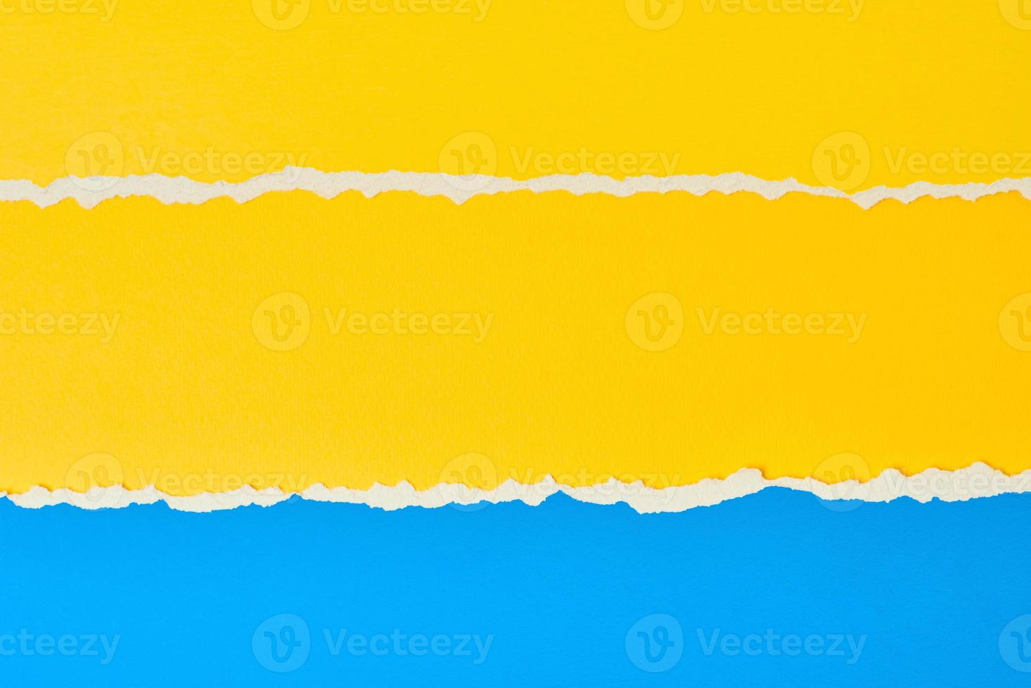 Torn ripped paper edge with a copy space, color blue and yellow background photo