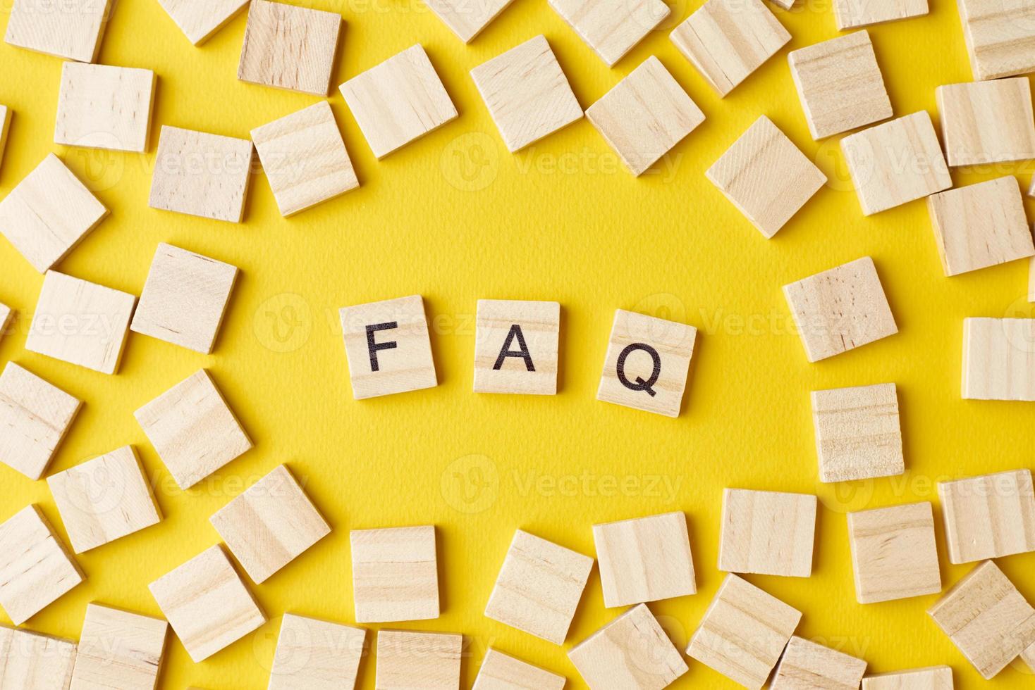 Wooden blocks with abbreviation FAQ on the yellow background photo