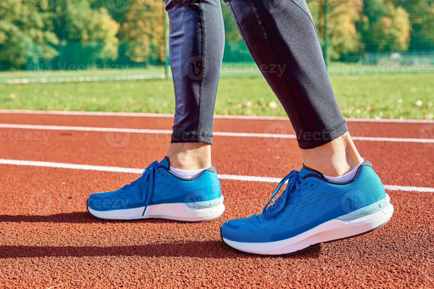 Running sneakers at stadium track photo