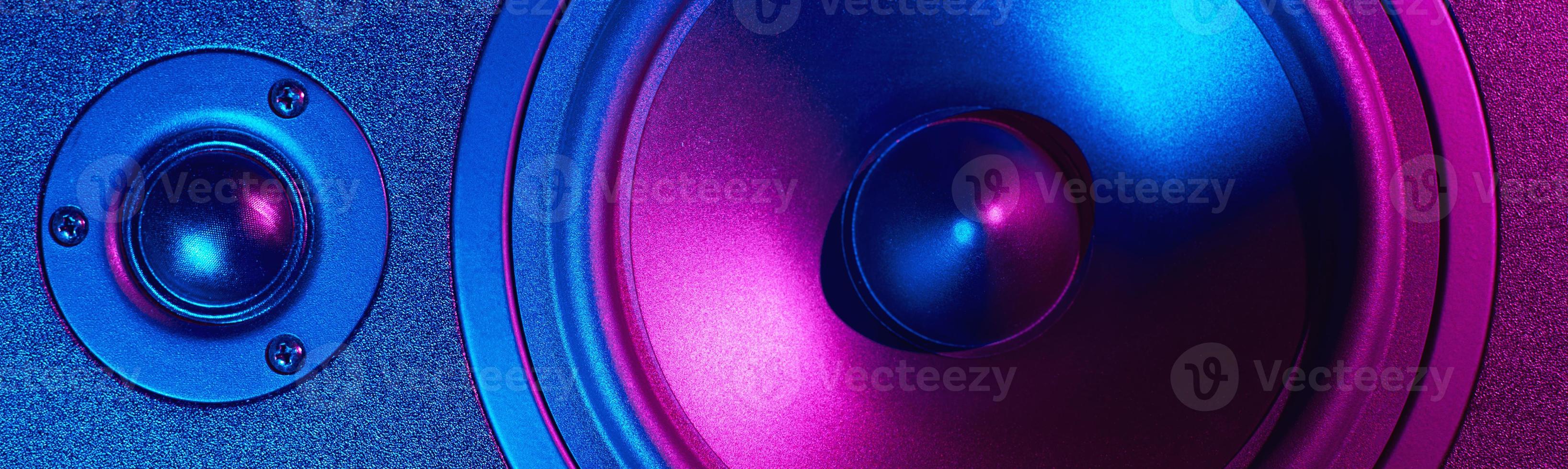 Sound audio speaker with neon lights on dark background photo