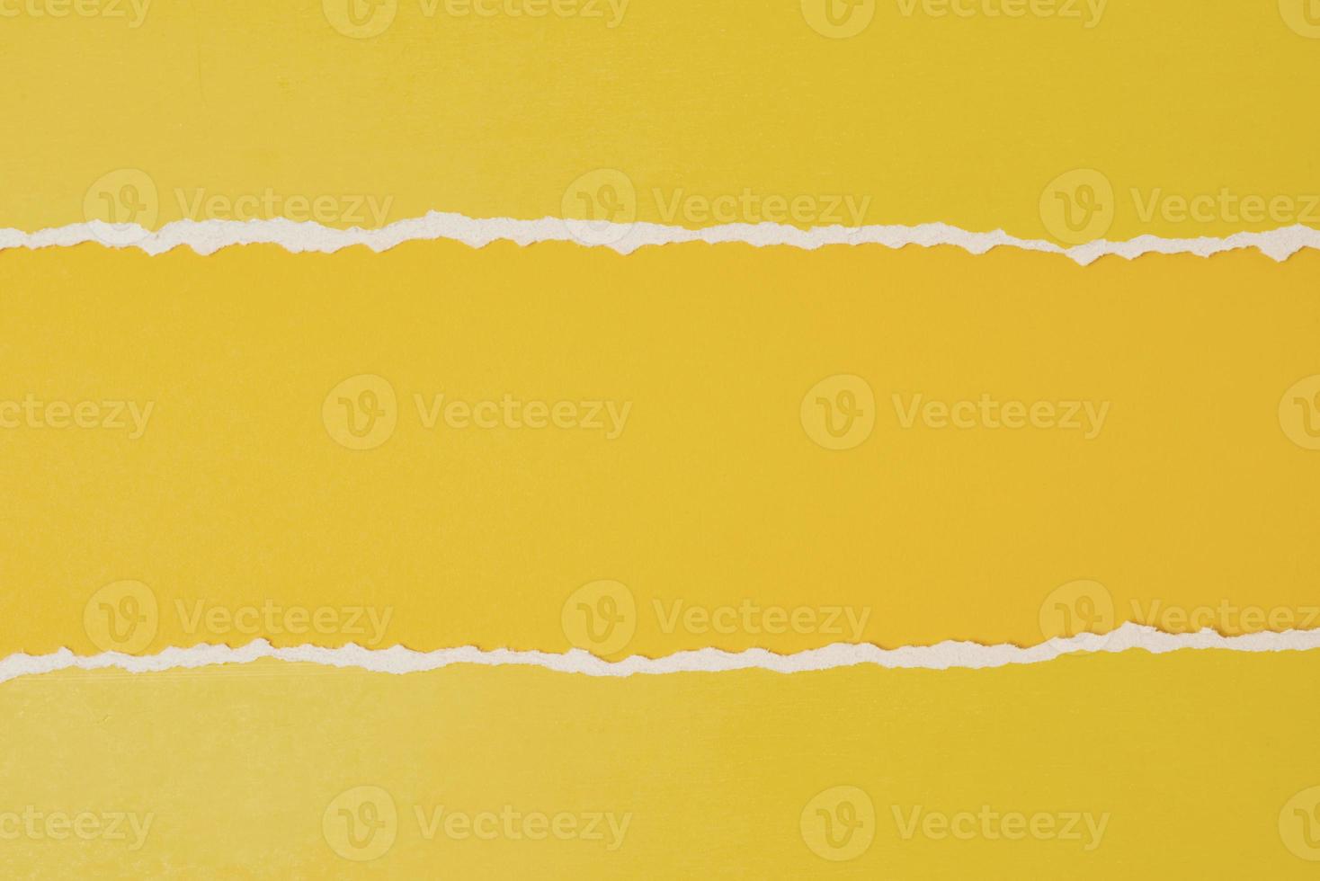 Torn ripped paper edge with a copy space, yellow color background photo