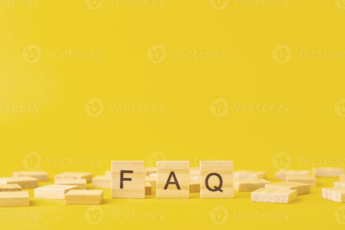 Wooden blocks with abbreviation FAQ on the yellow background photo