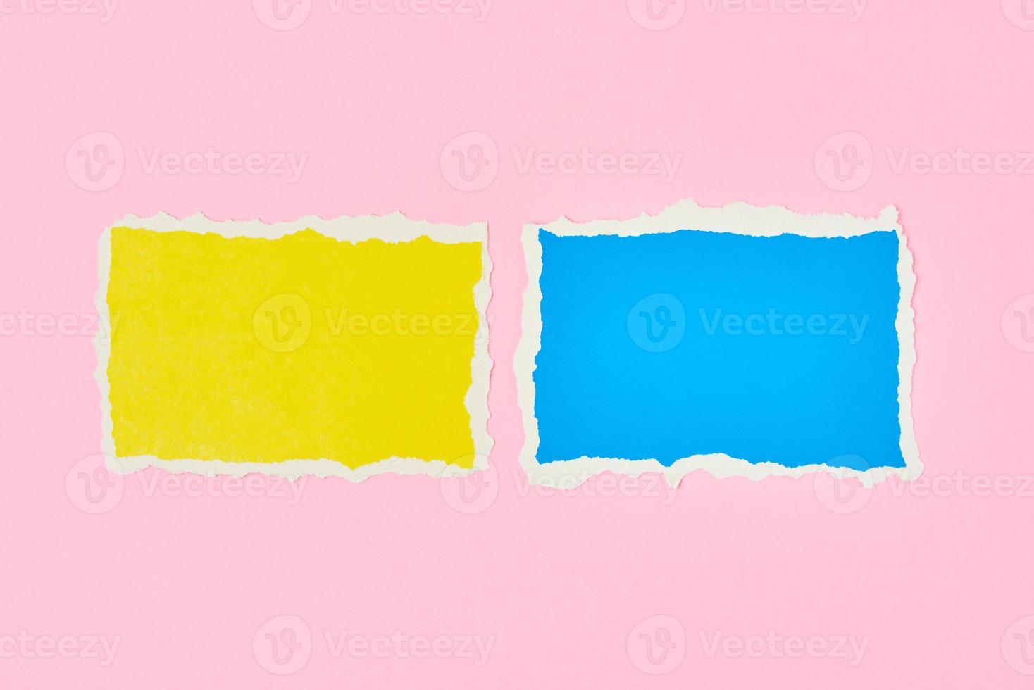 Two ripped paper torn edge sheets on a pink background photo