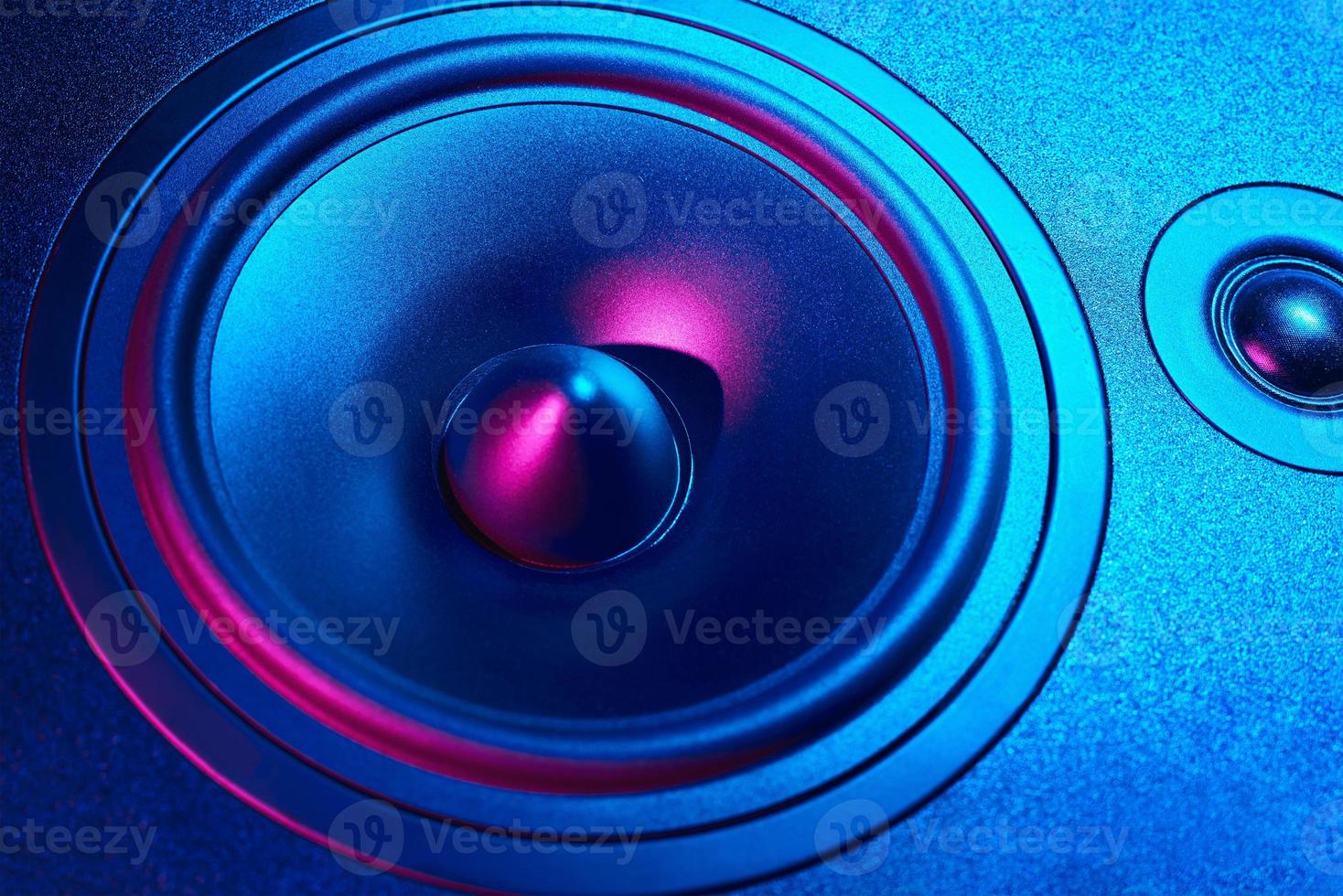 Sound audio speaker with neon lights on dark background photo
