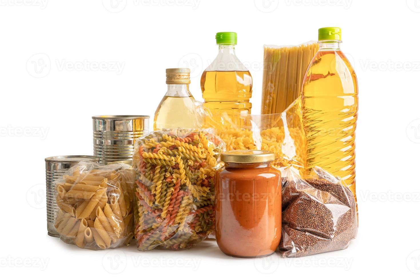 Foodstuff for donation isolated on white background with clipping path, storage and delivery. Various food, pasta, cooking oil and canned food in cardboard box. photo