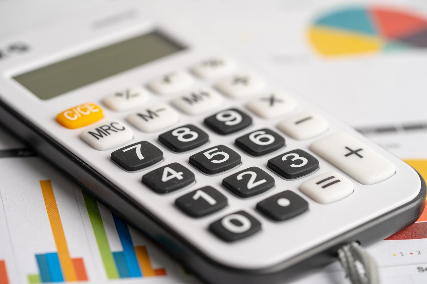 Calculator on graph. Finance development, Banking Account, Statistics Investment Analytic research data economy, trading, office reporting Business company meeting concept. photo