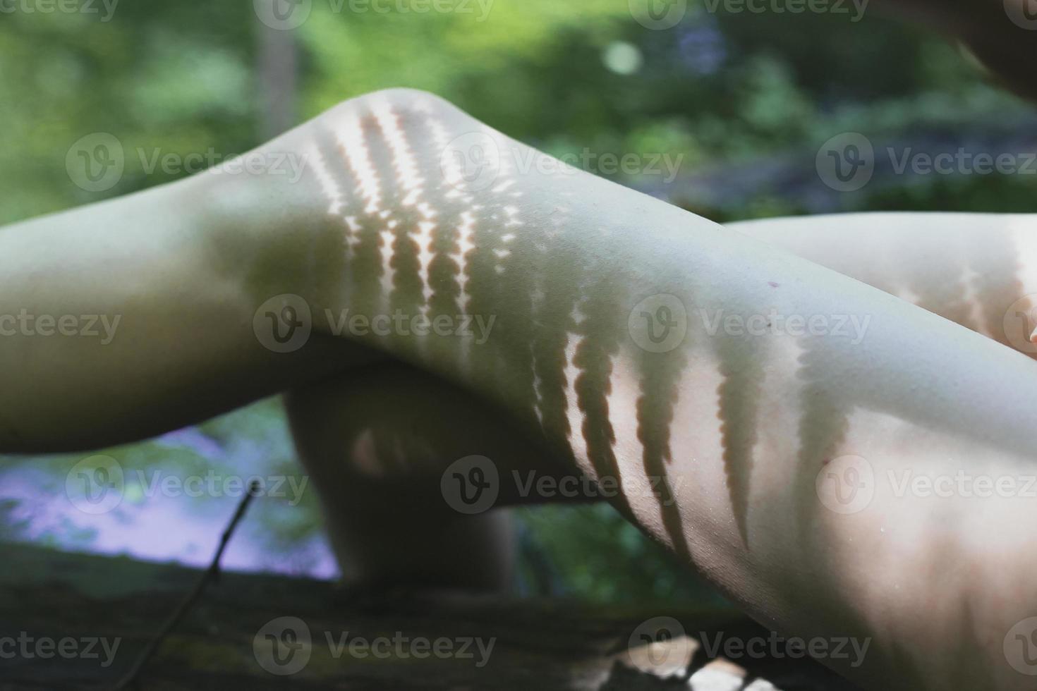 Close up female legs with plants shadow concept photo