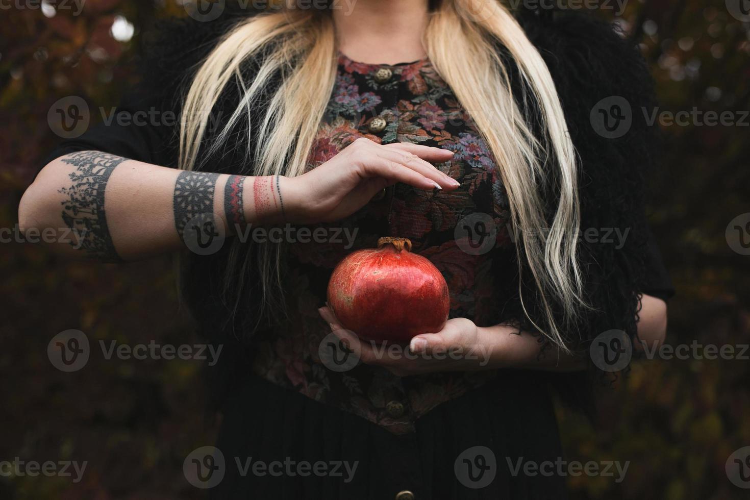 Close up woman holding pomegranate concept photo