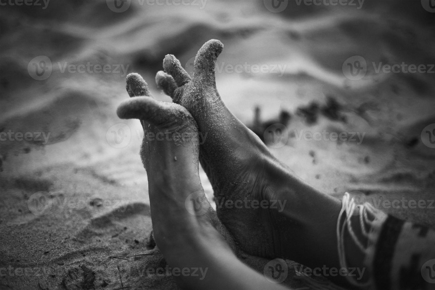 Close up funny feet on sandy beach monochrome concept photo