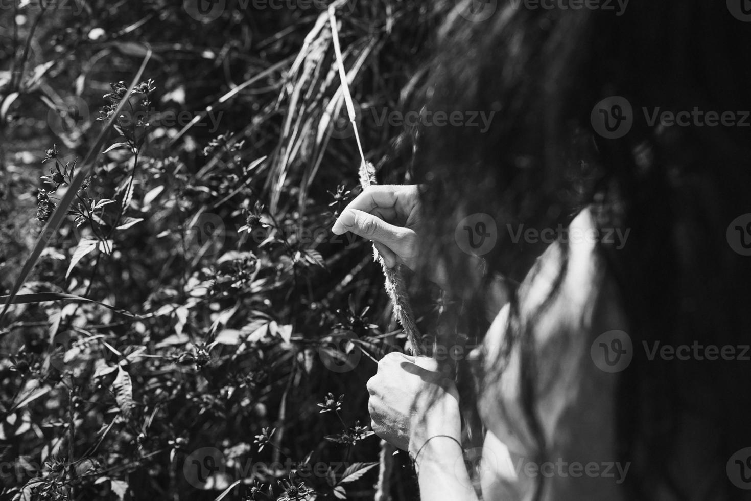 Close up beautiful naked lady caressing grass monochrome concept photo